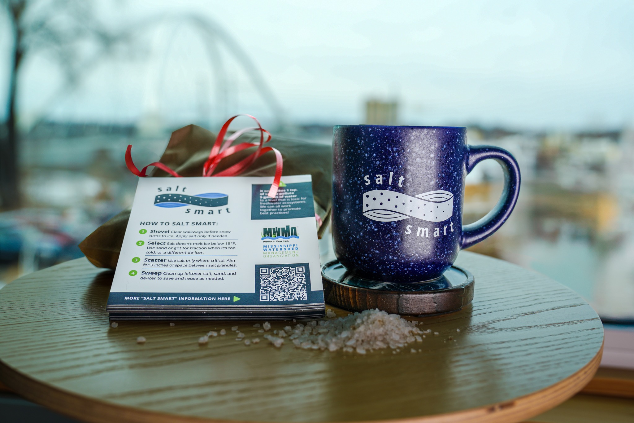 Winter Salt Week Smart Salting Mug Traction Grit and Magnets displayed on a table with loose rock salt