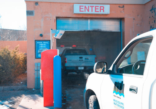MWMO trucks driving through the commercial car wash